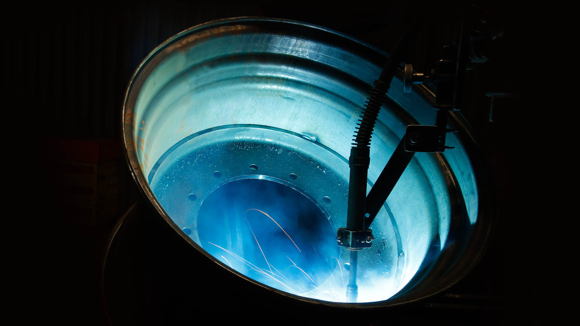 Close up picture of a tyre with the rim backlit with blue light